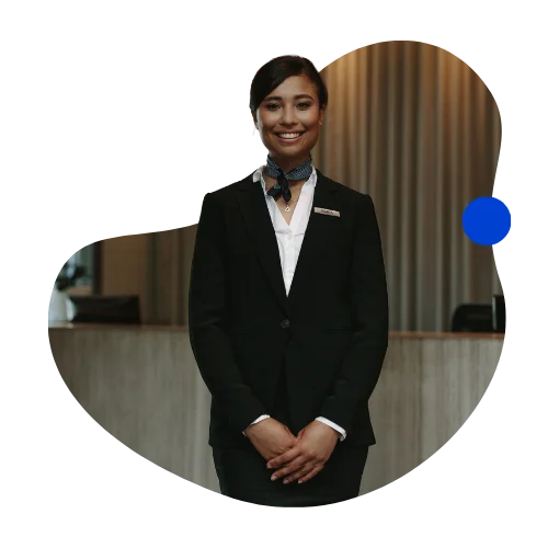 Friendly hotel front-desk associate welcoming guests