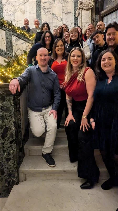 For-Sight team on staircase at holiday event