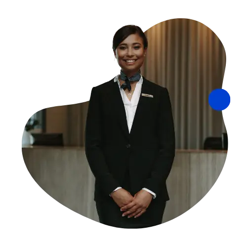 Friendly hotel front-desk associate welcoming guests