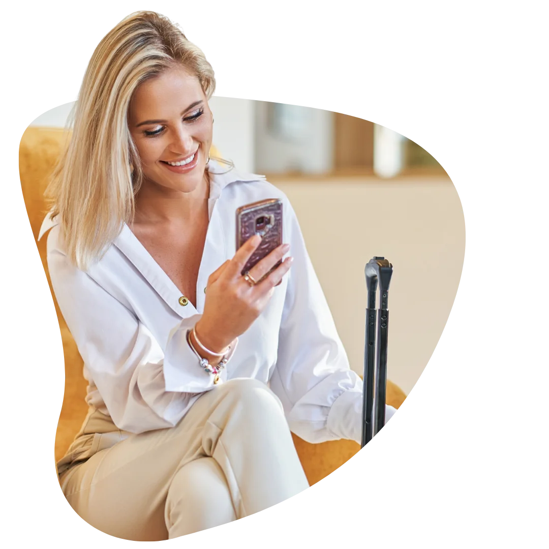 Stylish traveller in hotel lobby checking phone