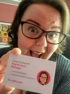 Carys Duckworth, Key Account Manager for For-Sight, holding a business card
